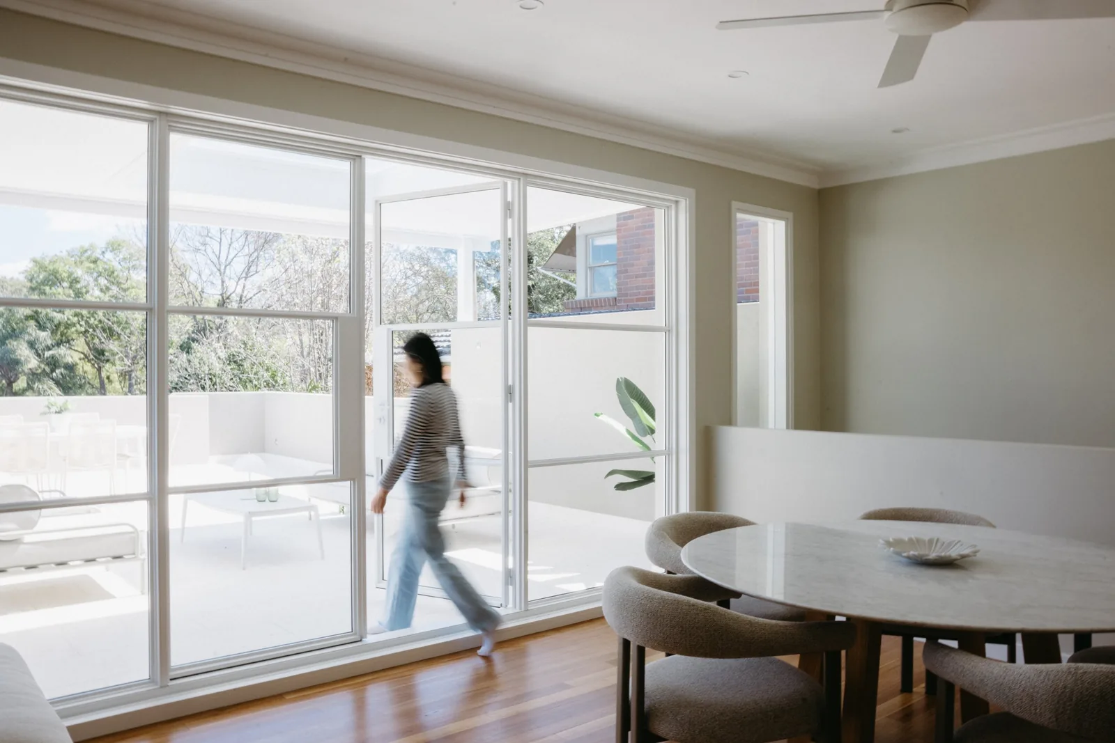 Person walking toward the French doors from the dining area