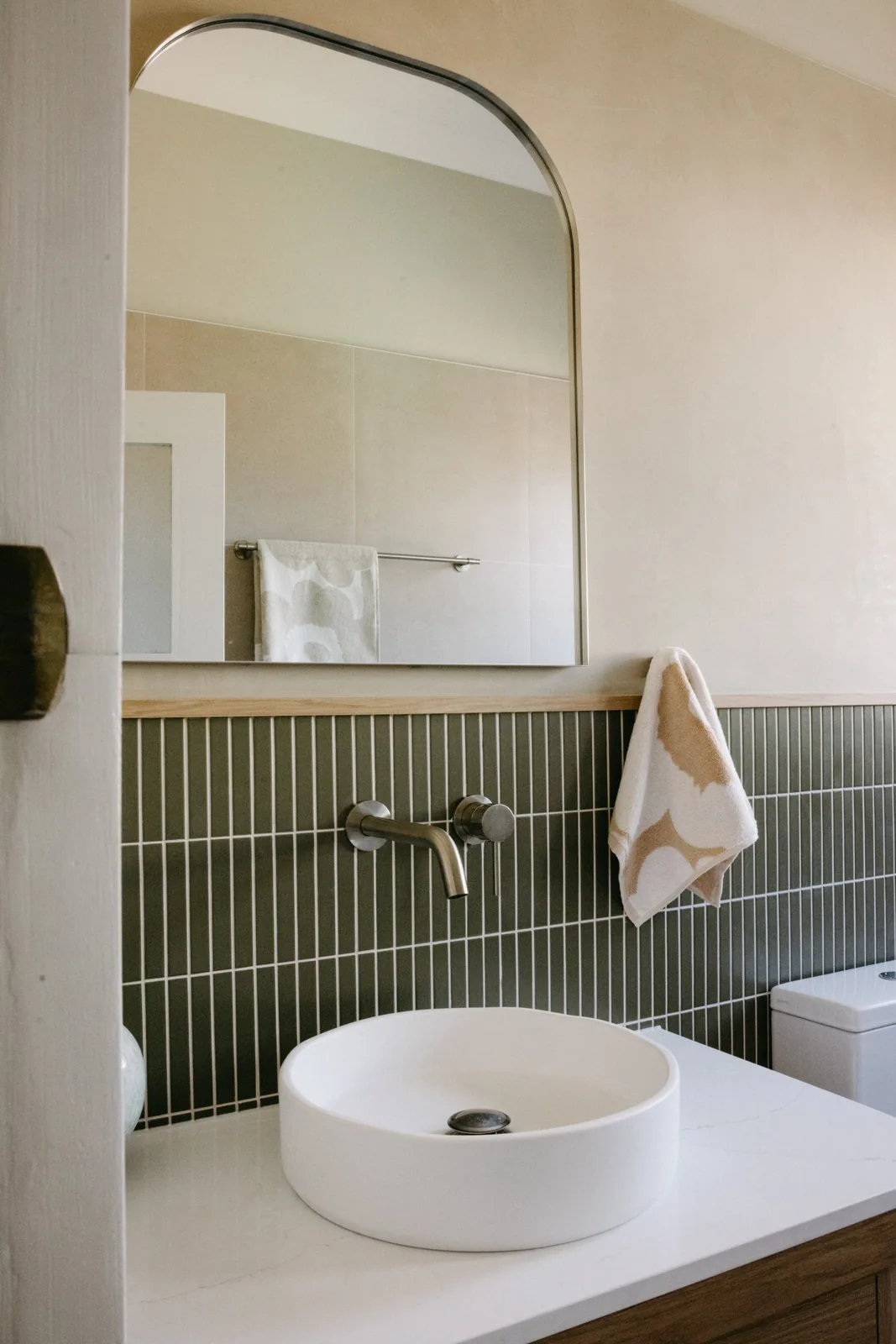 Artarmon main bathroom vanity with arched mirror and green tile