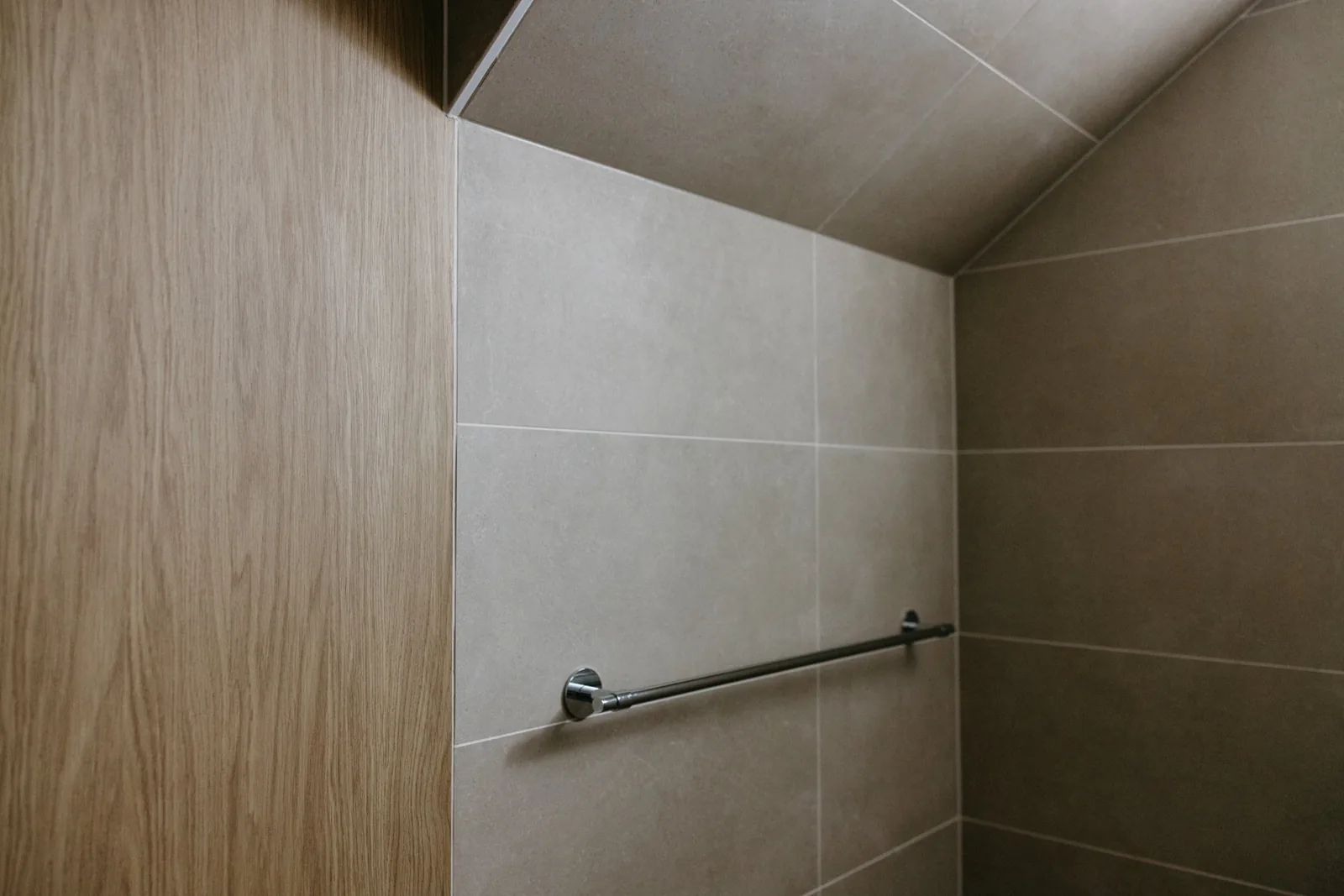 Timber joinery meeting tile with a towel rail