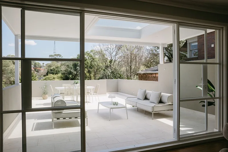 French doors opening from the living room onto the renewed deck
