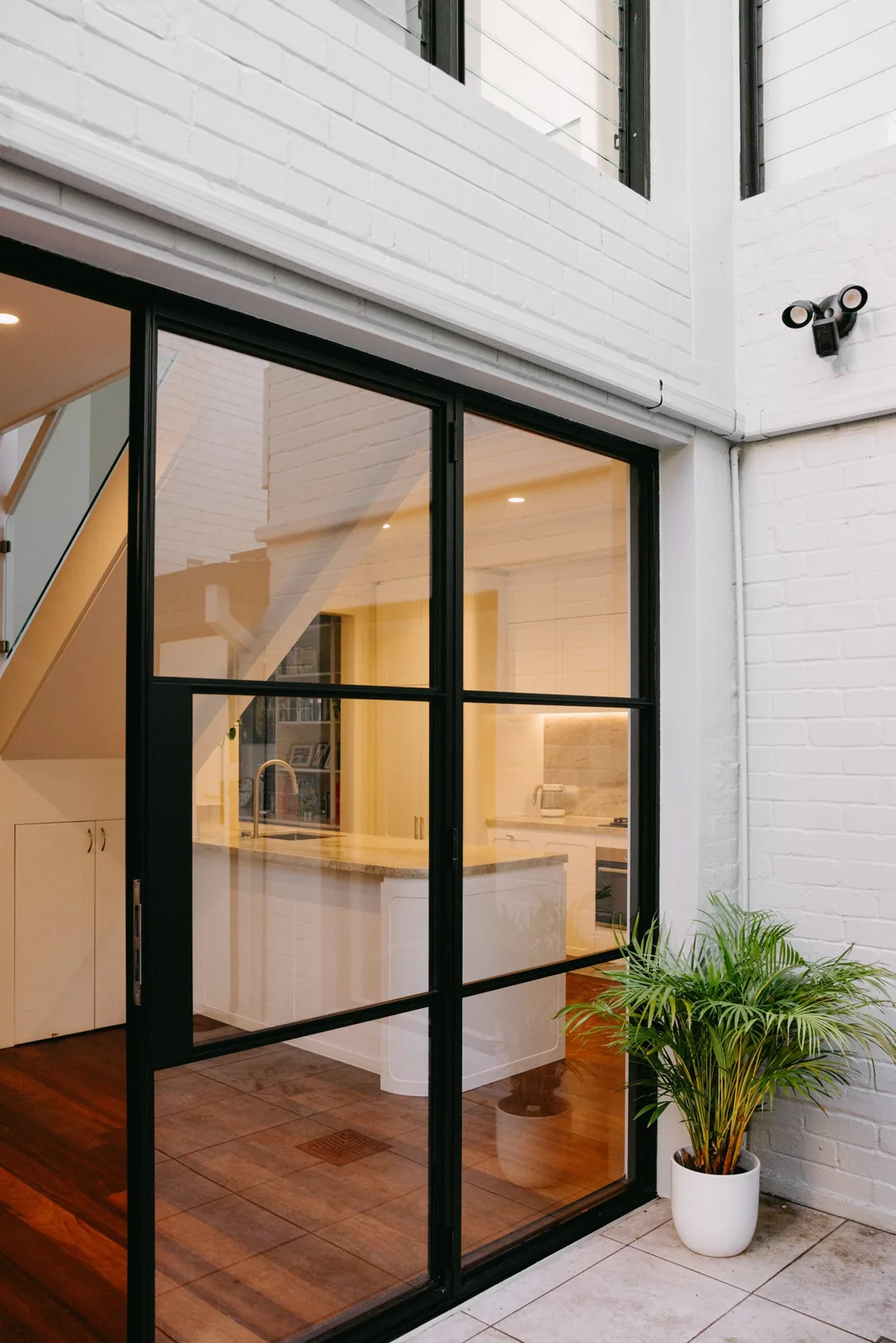 New black aluminium french doors from the courtyard