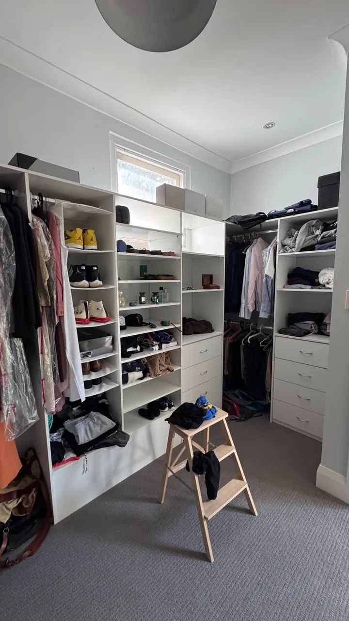 Robe room before renovation, with open shelving